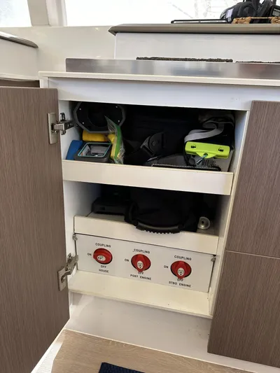 Encore Yacht Photos Pics Open cabinet on Bali 4.1 yacht, showing storage and control panel, 2020 model.