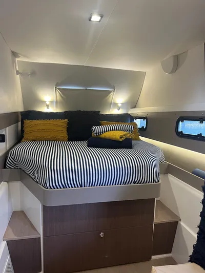 Encore Yacht Photos Pics Cozy bedroom in 2020 Bali 4.1 yacht with striped bedding and ambient lighting.