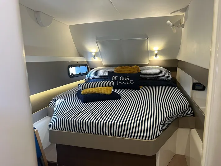 Encore Yacht Photos Pics Cozy bedroom in 2020 Bali 4.1 yacht with striped bedding and decorative pillows.