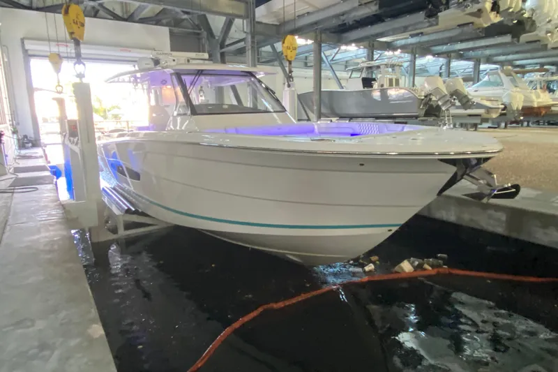  Yacht Photos Pics 2021 Regal 38 SAV boat in indoor storage, illuminated with blue lights.