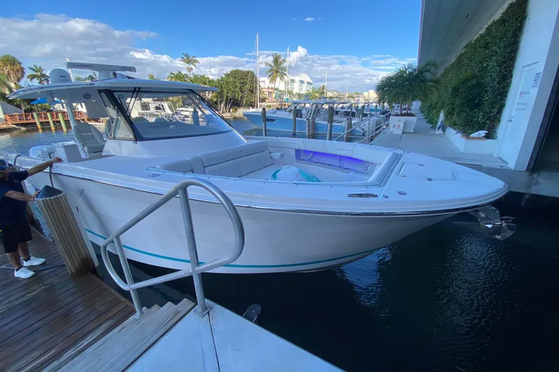  Yacht Photos Pics 2021 Regal 38 SAV boat docked at marina, featuring sleek design and modern amenities.