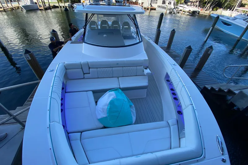  Yacht Photos Pics 2021 Regal 38 SAV luxury boat with spacious seating at a marina dock.