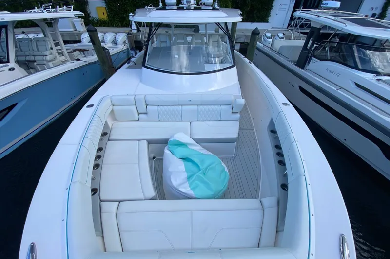  Yacht Photos Pics 2021 Regal 38 SAV luxury boat with spacious seating and sleek design at a marina.
