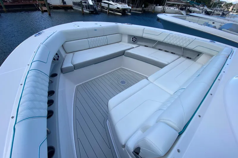  Yacht Photos Pics Luxurious seating area on a 2021 Regal 38 SAV boat, docked by the water.