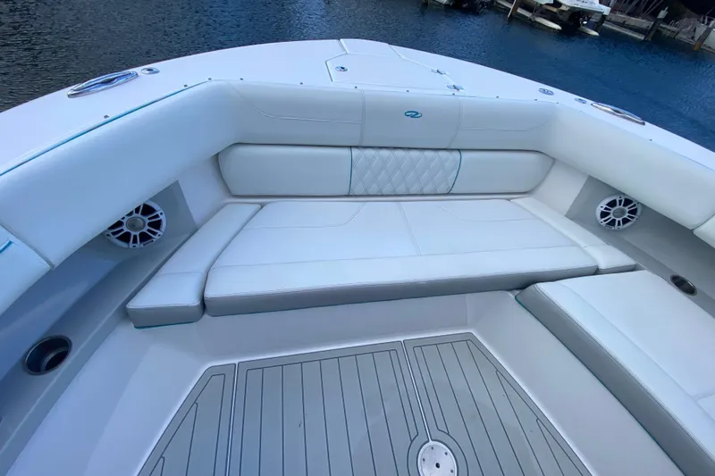  Yacht Photos Pics Luxurious seating area on 2021 Regal 38 SAV boat, featuring white upholstery and speakers.