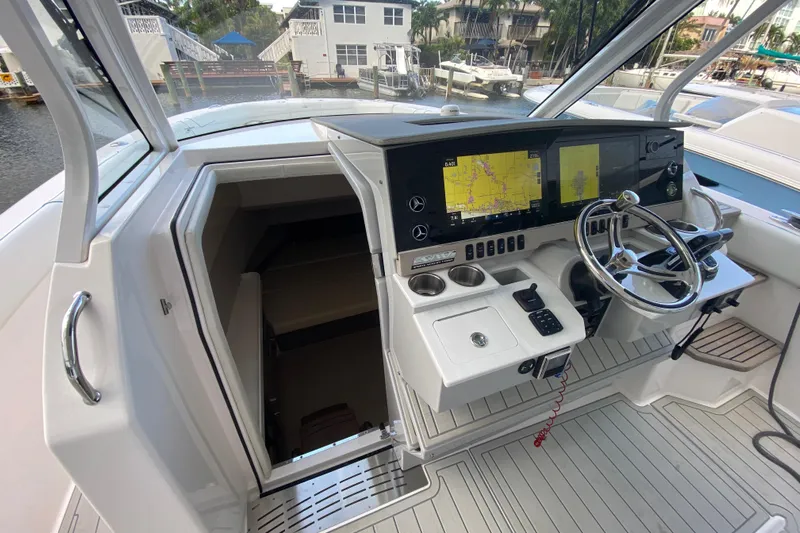  Yacht Photos Pics 2021 Regal 38 SAV boat cockpit with navigation screens and steering wheel.