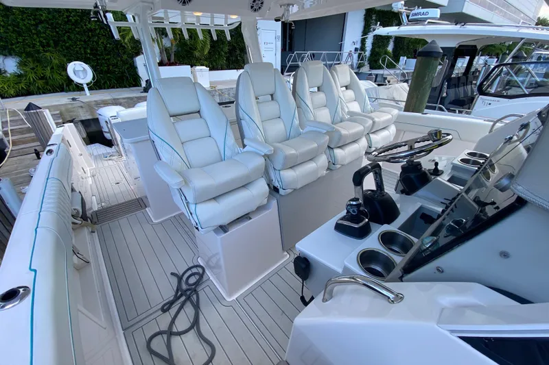  Yacht Photos Pics 2021 Regal 38 SAV boat interior with luxurious white seating and modern controls.
