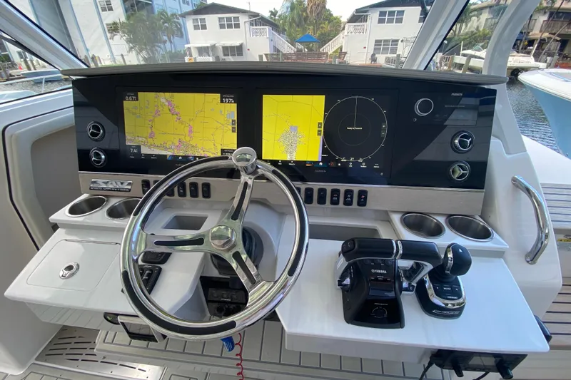  Yacht Photos Pics 2021 Regal 38 SAV boat helm with dual navigation screens and steering wheel.