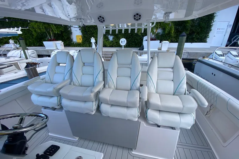 Yacht Photos Pics Luxurious seating on 2021 Regal 38 SAV boat, featuring four plush captain's chairs.