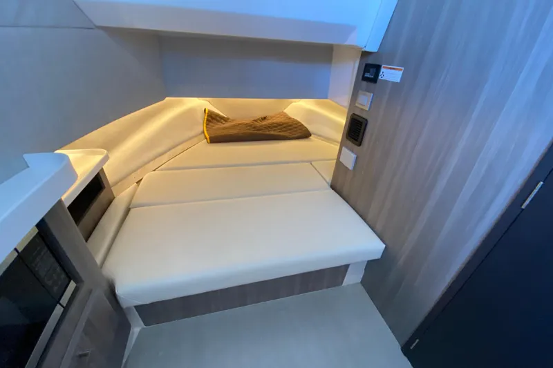  Yacht Photos Pics 2021 Regal 38 SAV interior cabin with cushioned seating and ambient lighting.