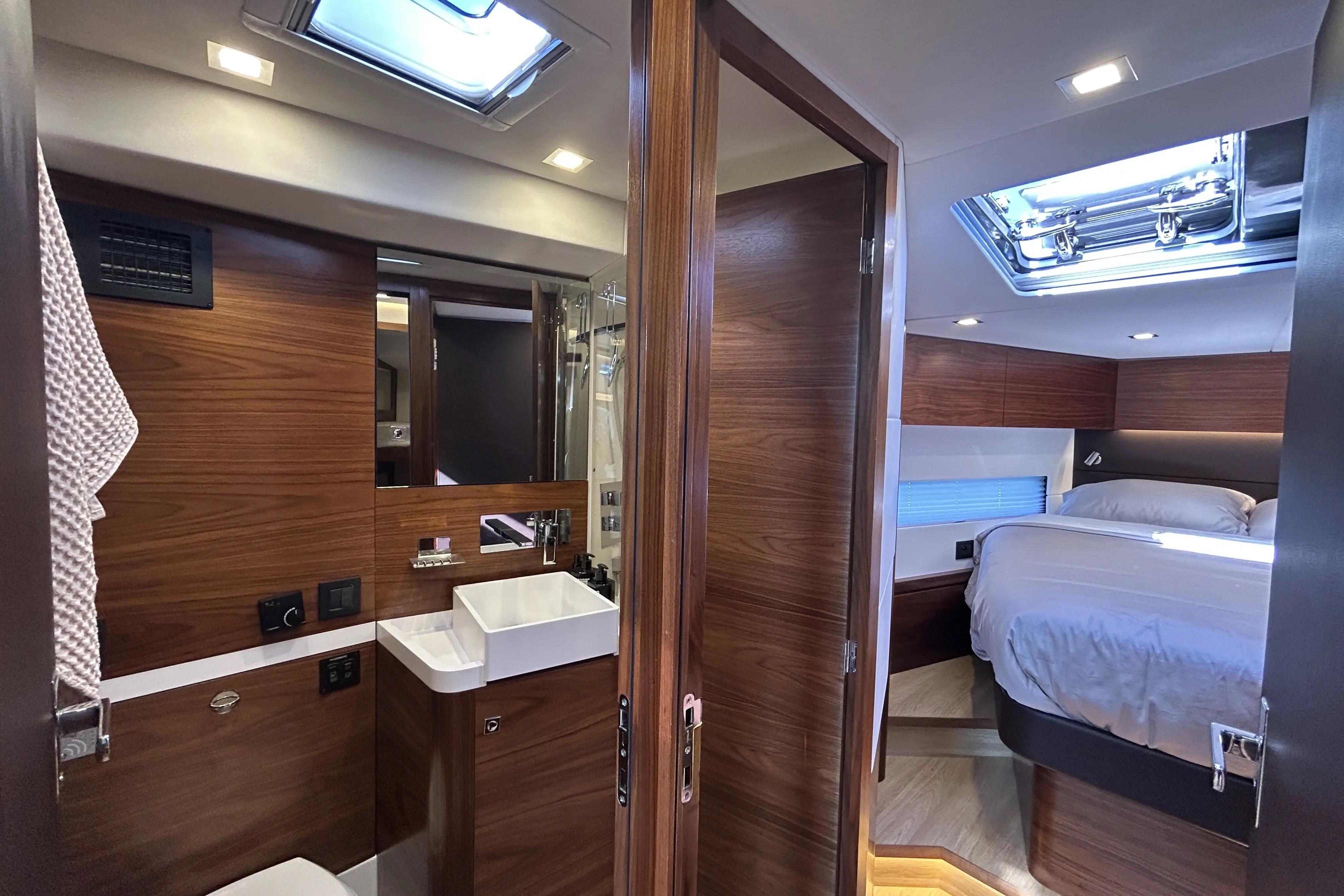 Luxurious interior of 2022 Amel 50 yacht featuring a modern bathroom and cozy bedroom.