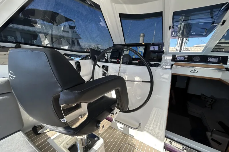  Yacht Photos Pics Modern helm station of 2022 Amel 50 yacht with navigation equipment and captain's chair.
