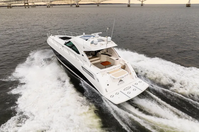  Yacht Photos Pics 2013 Sea Ray 540 Sundancer yacht cruising on open water near a bridge.