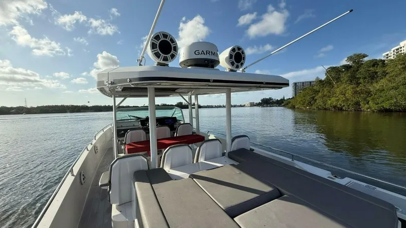 No Name Yacht Photos Pics 2019 Axopar 37 Sun Top boat on calm water, featuring spacious seating and Garmin equipment.