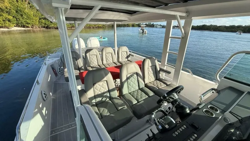 No Name Yacht Photos Pics 2019 Axopar 37 Sun Top boat interior with seating, steering console, and scenic water view.