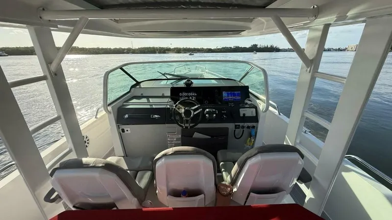 No Name Yacht Photos Pics 2019 Axopar 37 Sun Top boat interior with helm, steering wheel, and navigation equipment.