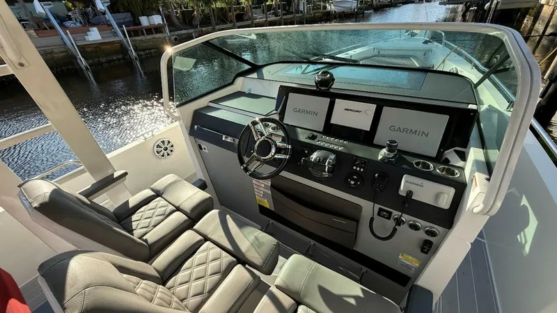 No Name Yacht Photos Pics 2019 Axopar 37 Sun Top helm with dual Garmin displays and luxurious seating.