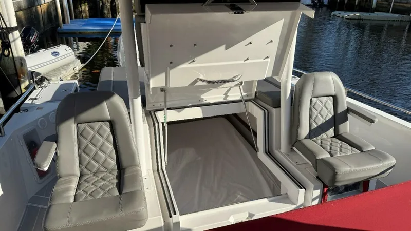 No Name Yacht Photos Pics 2019 Axopar 37 Sun Top boat interior with open storage and cushioned seats.