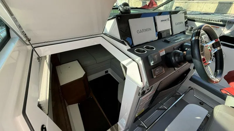 No Name Yacht Photos Pics 2019 Axopar 37 Sun Top cockpit with Garmin navigation and cabin entrance.
