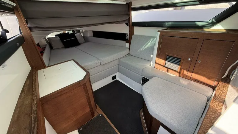 No Name Yacht Photos Pics 2019 Axopar 37 Sun Top cabin interior with cozy seating and wooden cabinetry.