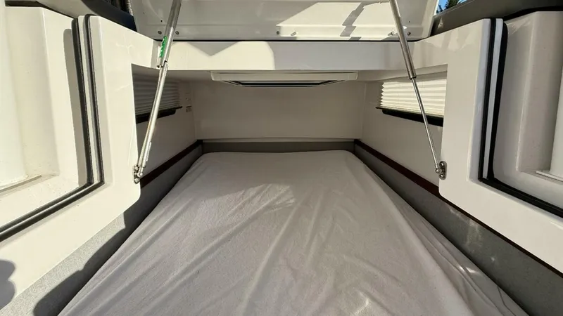 No Name Yacht Photos Pics 2019 Axopar 37 Sun Top cabin interior with bed and open hatch.