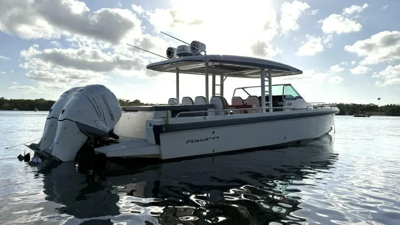 No Name Yacht Photos Pics 2019 Axopar 37 Sun Top boat on calm water under cloudy sky.