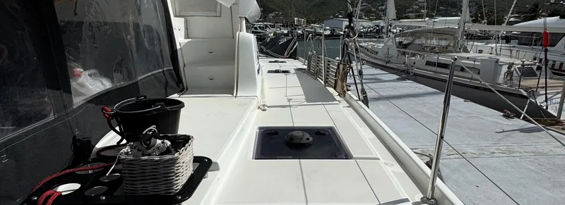 Samcat Yacht Photos Pics Deck view of a 2020 Lagoon 46 catamaran docked at a marina.