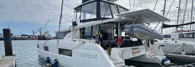 Samcat Yacht Photos Pics 2020 Lagoon 46 catamaran docked at marina, featuring modern design and spacious deck.