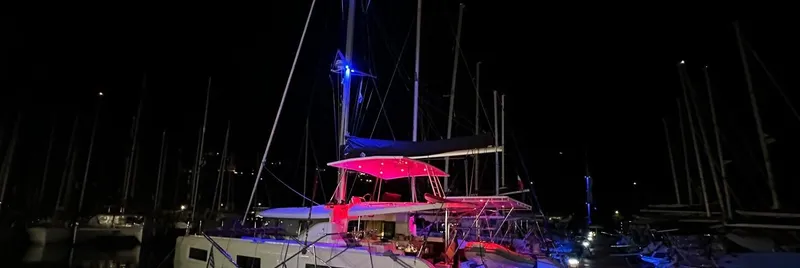 Samcat Yacht Photos Pics 2020 Lagoon 46 catamaran illuminated at night in a marina.