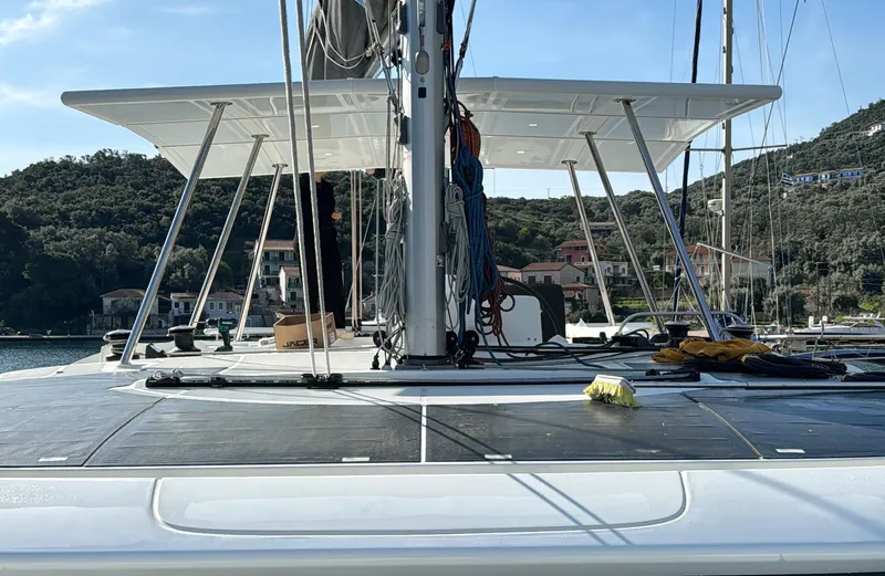 Samcat Yacht Photos Pics Lagoon 46 catamaran deck view, 2020 model, docked in a scenic marina.