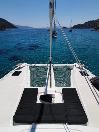 Samcat Yacht Photos Pics Lagoon 46 catamaran sailing in clear blue waters, 2020 model, with scenic coastal views.