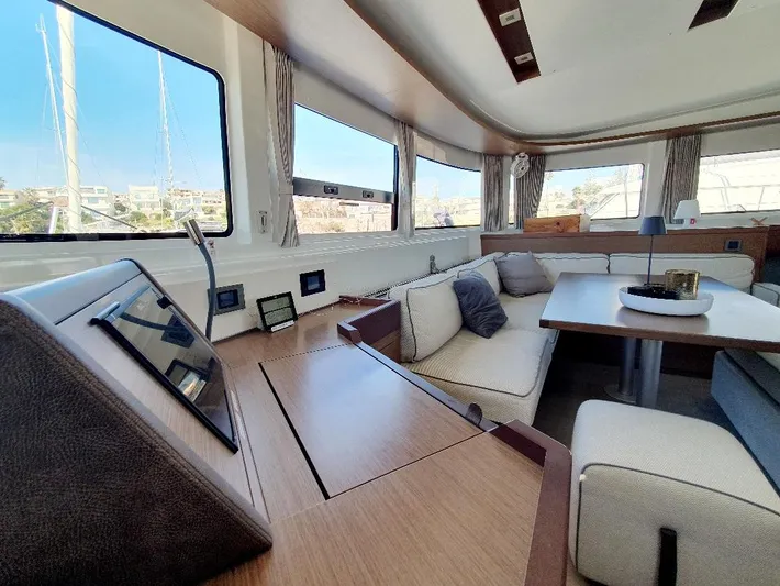 Samcat Yacht Photos Pics Luxurious interior of 2020 Lagoon 46 catamaran with modern seating and panoramic windows.