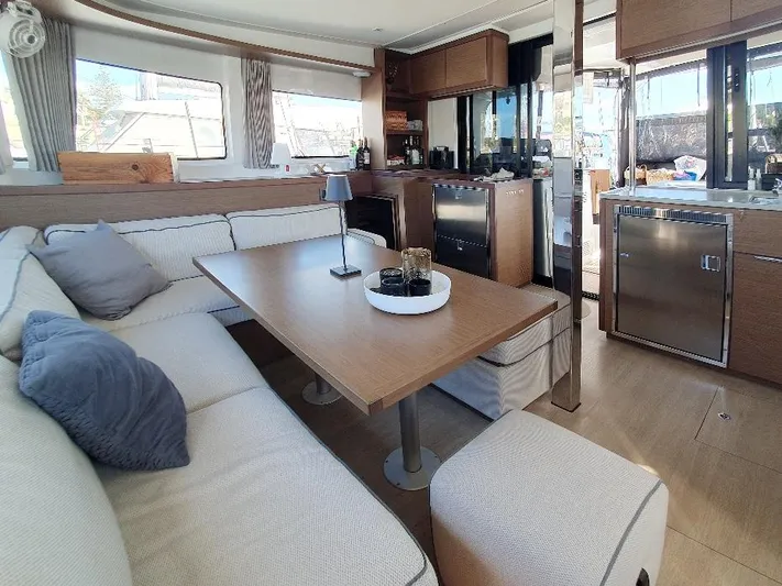 Samcat Yacht Photos Pics Luxurious interior of 2020 Lagoon 46 yacht with modern kitchen and cozy seating area.