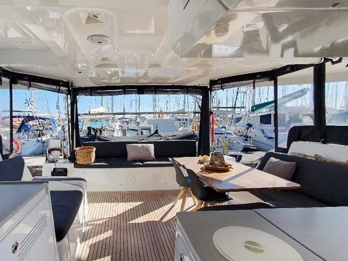Samcat Yacht Photos Pics Spacious interior of 2020 Lagoon 46 catamaran with modern seating and dining area.