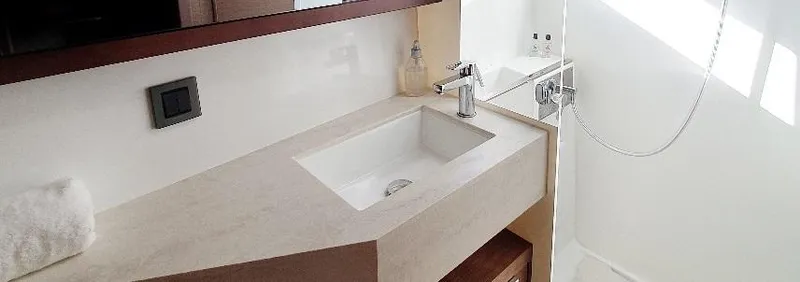 Samcat Yacht Photos Pics Modern bathroom in 2020 Lagoon 46 yacht with sleek sink and shower area.