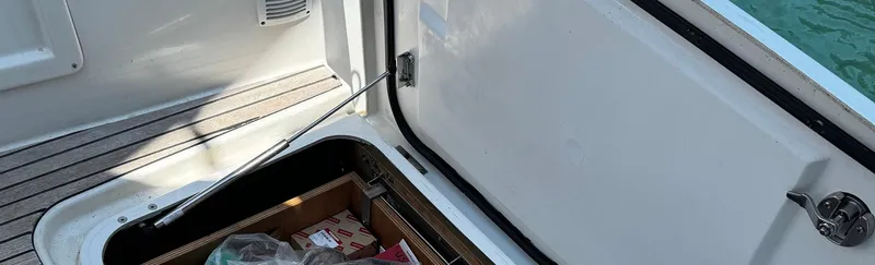 Samcat Yacht Photos Pics Open storage compartment on a 2020 Lagoon 46 yacht, revealing supplies and equipment.