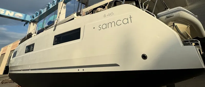 Samcat Yacht Photos Pics 2020 Lagoon 46 catamaran in a shipyard, showcasing sleek design and modern features.