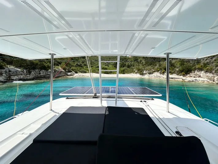 Samcat Yacht Photos Pics Lagoon 46 catamaran, 2020 model, anchored in a serene turquoise bay with solar panels.