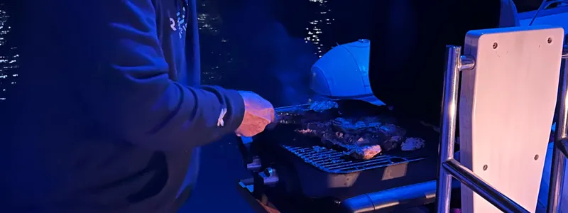 Samcat Yacht Photos Pics Person grilling on a Lagoon 46 yacht at night, 2020 model.
