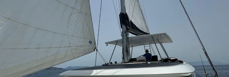 Samcat Yacht Photos Pics 2020 Lagoon 46 sailing catamaran on open water with sails unfurled.