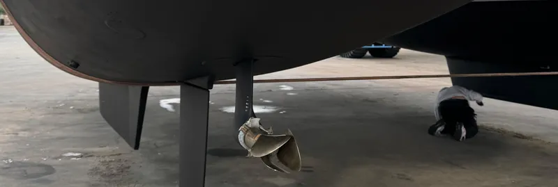 Samcat Yacht Photos Pics Underneath view of a 2020 Lagoon 46 catamaran in a shipyard.