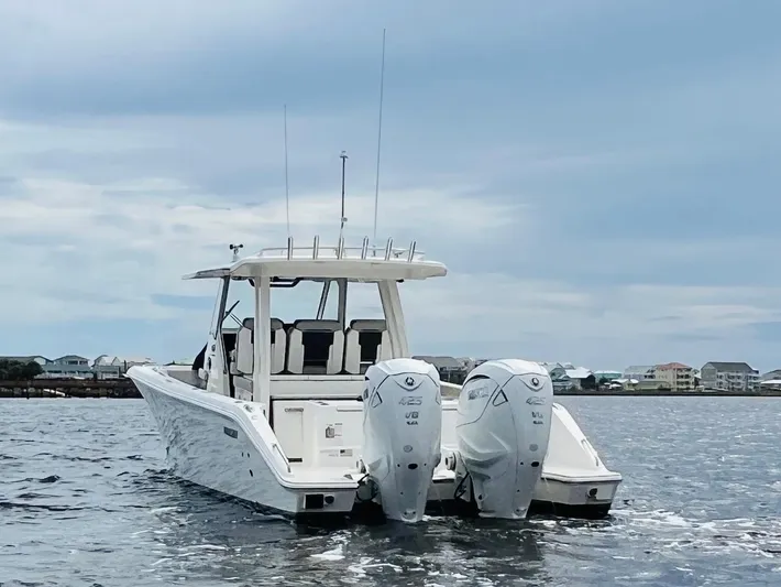  Yacht Photos Pics 2022 Pursuit S 358 Sport boat with dual engines on open water.