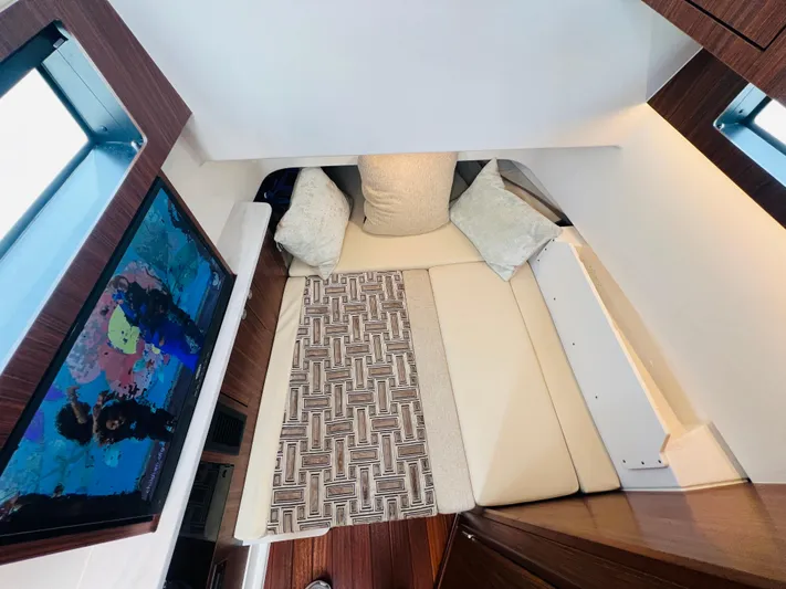  Yacht Photos Pics 2022 Pursuit S 358 Sport cabin interior with cozy bed and decorative pillows.