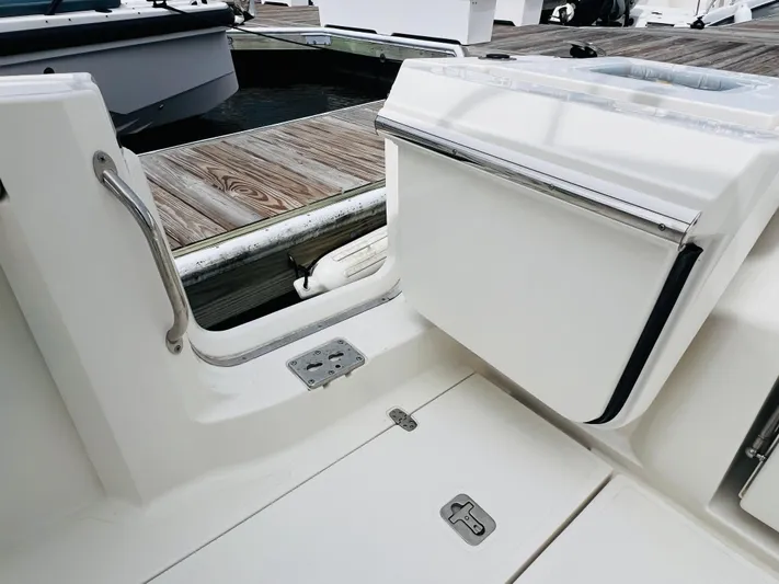 Yacht Photos Pics 2022 Pursuit S 358 Sport boat interior with open hatch and dock view.