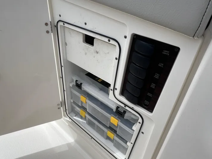  Yacht Photos Pics 2022 Pursuit S 358 Sport storage compartment with organized tackle boxes and control panel.
