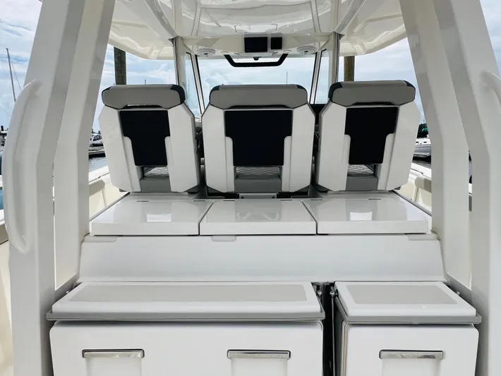  Yacht Photos Pics 2022 Pursuit S 358 Sport boat interior with sleek seating and storage compartments.