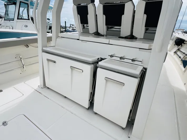  Yacht Photos Pics 2022 Pursuit S 358 Sport boat interior with seating and storage compartments.