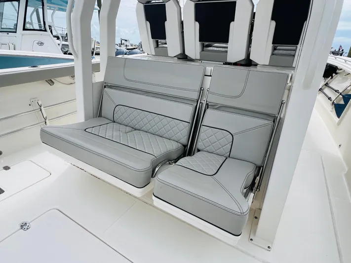  Yacht Photos Pics 2022 Pursuit S 358 Sport boat interior with gray cushioned seating.