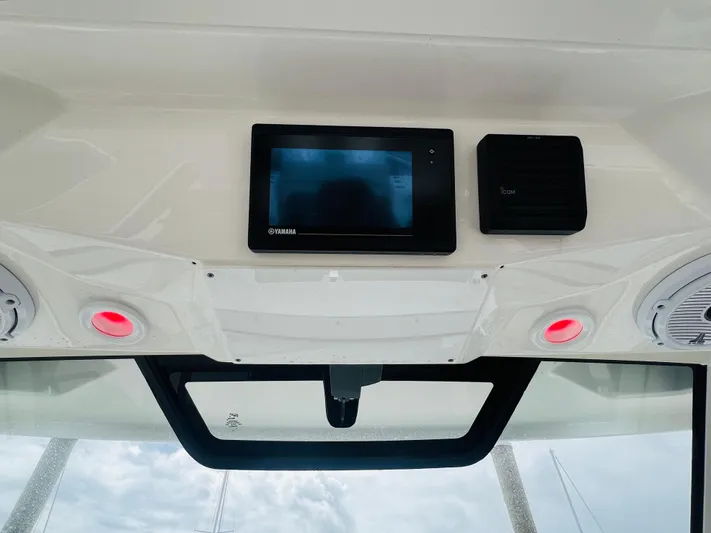  Yacht Photos Pics 2022 Pursuit S 358 Sport boat dashboard with electronic display and speakers.