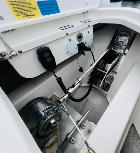  Yacht Photos Pics 2022 Pursuit S 358 Sport boat anchor compartment with control panel and winch system.